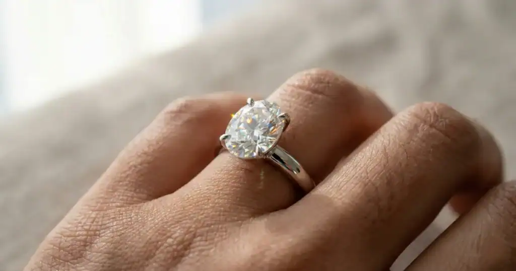 2 carat solitaire diamond ring price guide showing oval cut lab-grown diamond on woman's hand