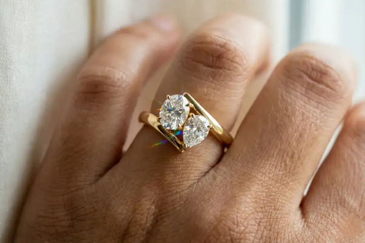 Toi et moi engagement ring trend 2026 oval and pear lab grown diamonds bypass setting yellow gold