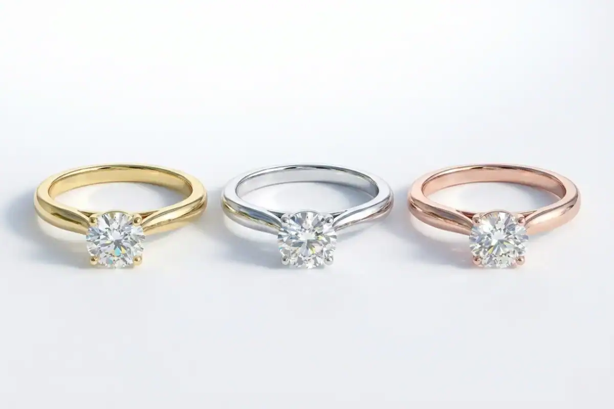 Solitaire ring in three metal options showing 18K yellow gold white gold and rose gold side by side